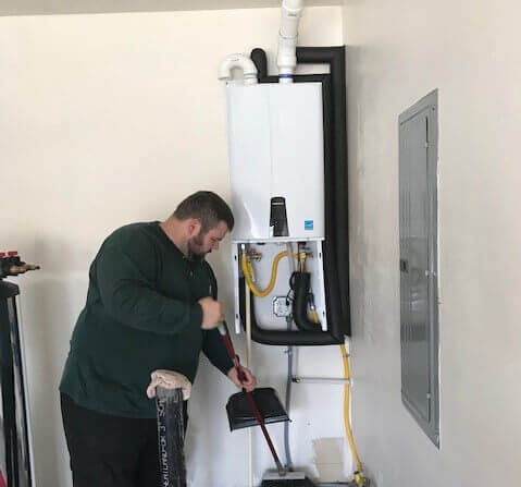 Plumbing Connection technician servicing tankless water heater