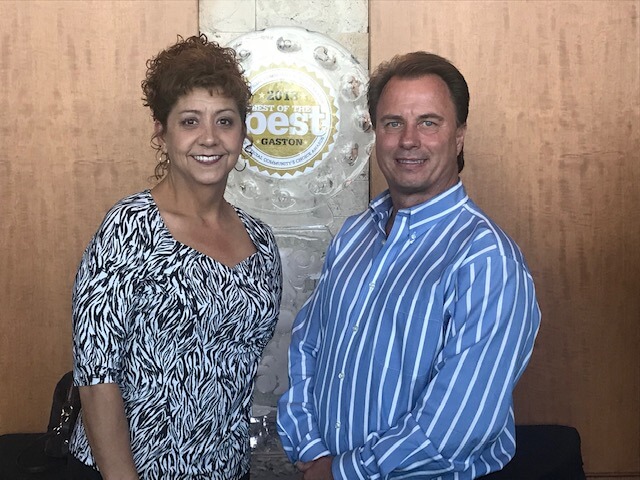 Jim Bridges, President of Plumbing Connection, with a team member at an award ceremony